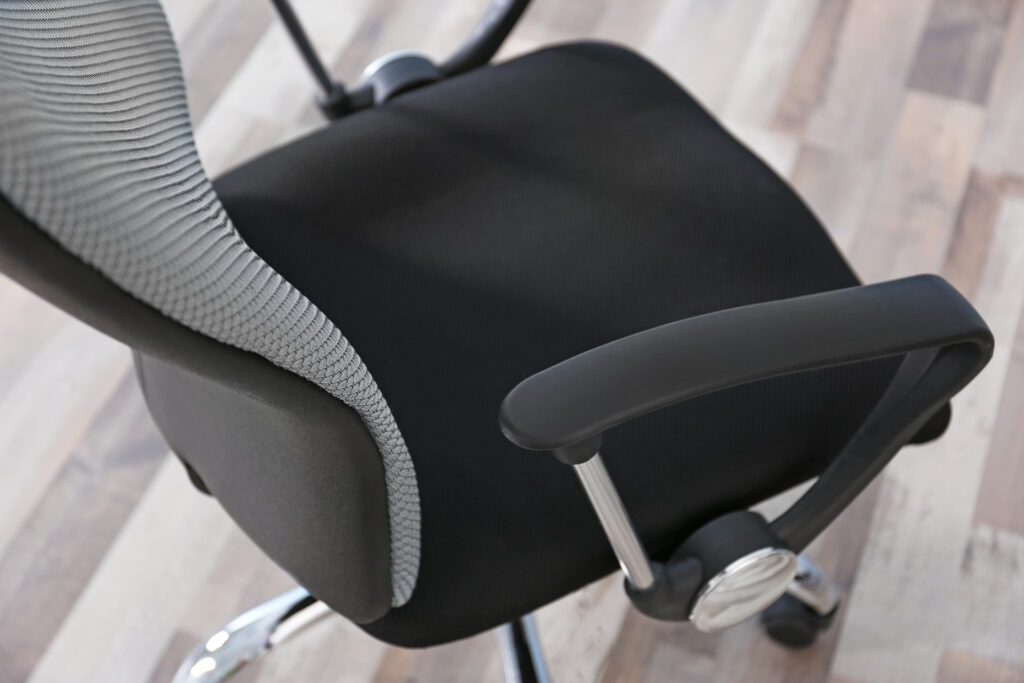 office massage chair black on wooden floorboard